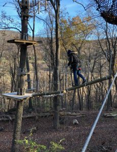 Lauren of Mom Home Guide navigates a lofty obstacle at the TreEscape course at Mountain Creek