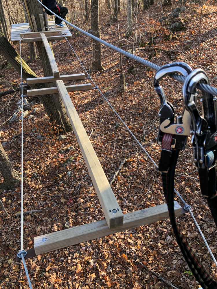 An aerial obstacle and two of the safety carabiners that each obstacle course participant has on her harness at TreEscape Aerial Adventures Ropes Course at Mountain Creek in Vernon, NJ