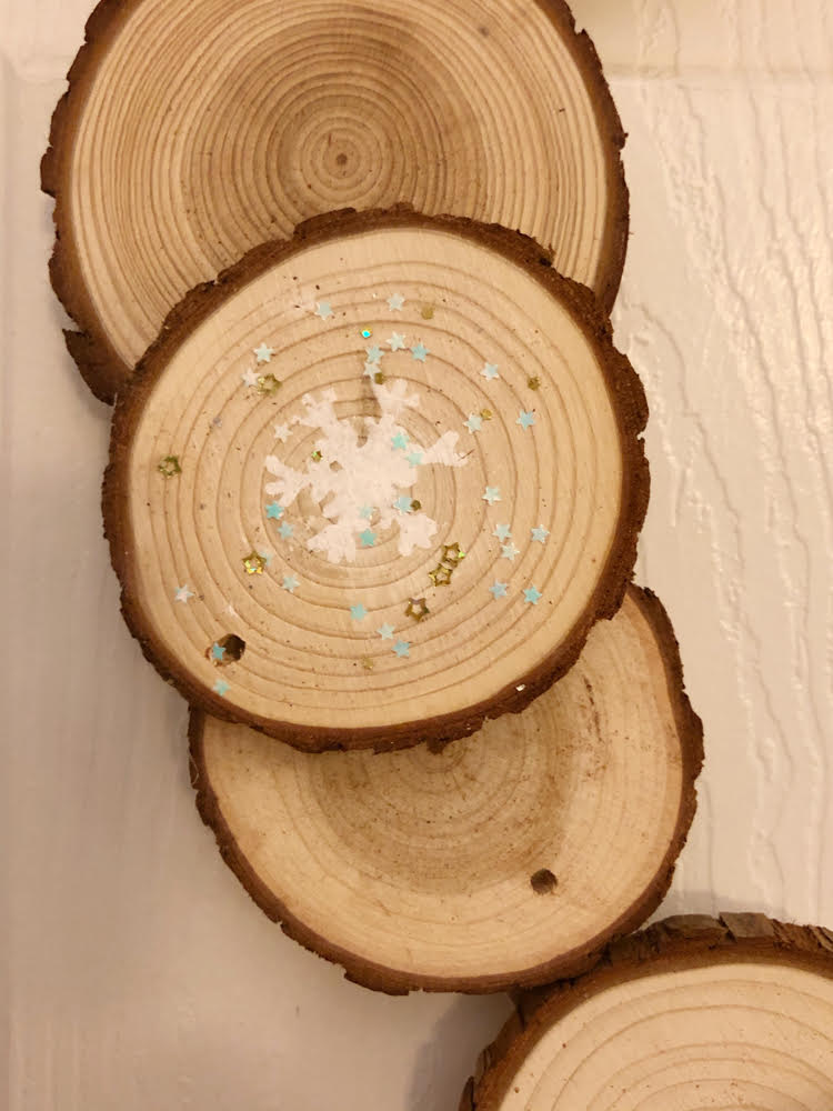 Snowflakes stenciled on a wood slice wreath