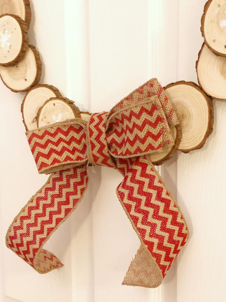 A handmade burlap bow for a DIY wood slice wreath