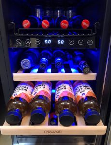 Kombucha in a sleek wine/beverage fridge by NewAir