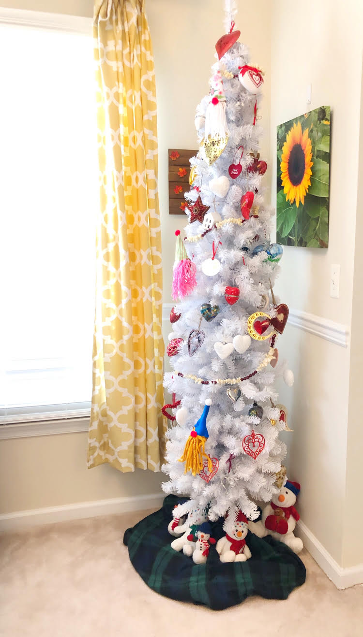 A white Valentine's Day tree decorated with heart ornaments