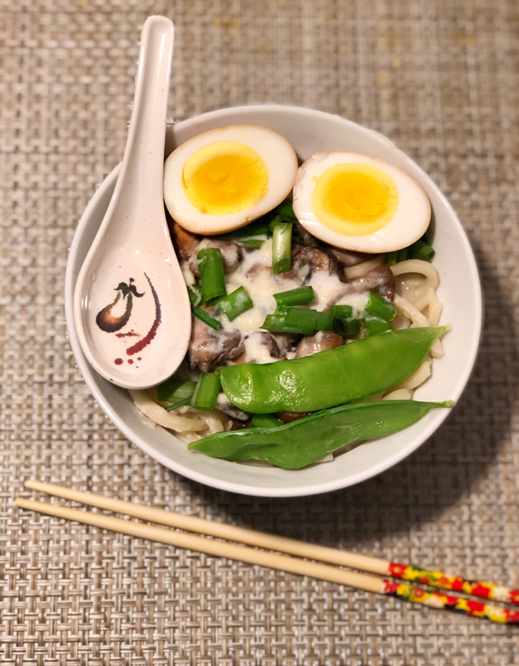 This easy mushroom udon soup recipe is topped with a creamy Swiss cheese sauce and a soy egg. Yum!