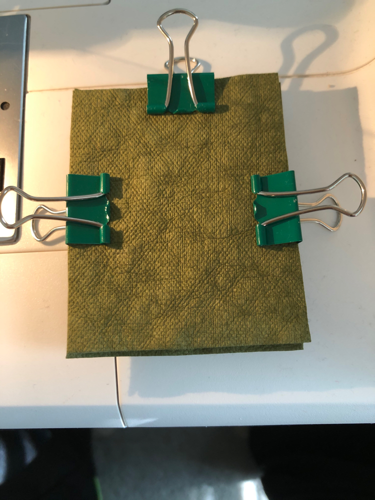 Using clips to keep Kraft-tex layers together while sewing.
