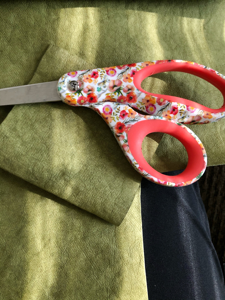 Use a sharp pair of sewing scissors to cut Kraft tex, which is a paper that acts like fabric and looks like leather.