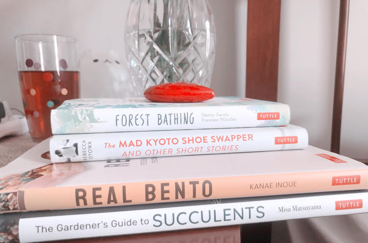 Books Forest Bathing, The Mad Kyoto Shoe Swapper, Real Bento, and The Gardener's Guide to Succulents on a nightstand. All books are by Tuttle Publishing.