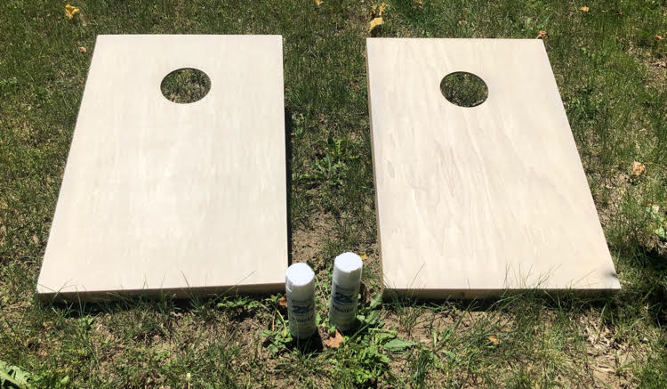 Spray paint makes it easy to have DIY painted corn hole boards. With just a little painter's tape, you can easily paint stripes on corn hole boards.