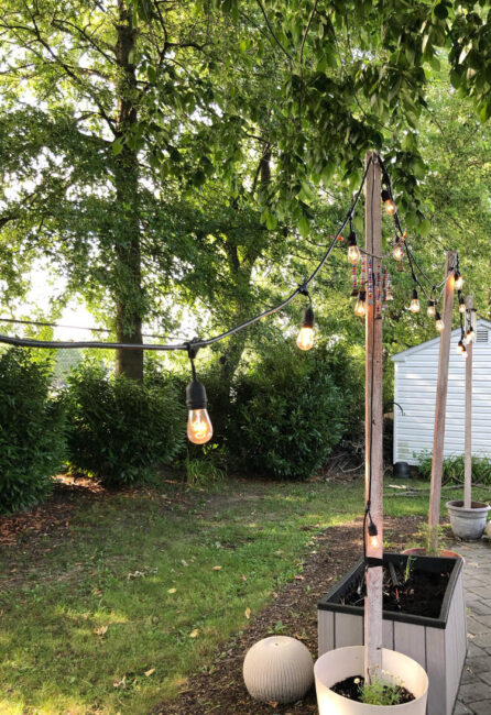 string lights hung from DIY planter posts