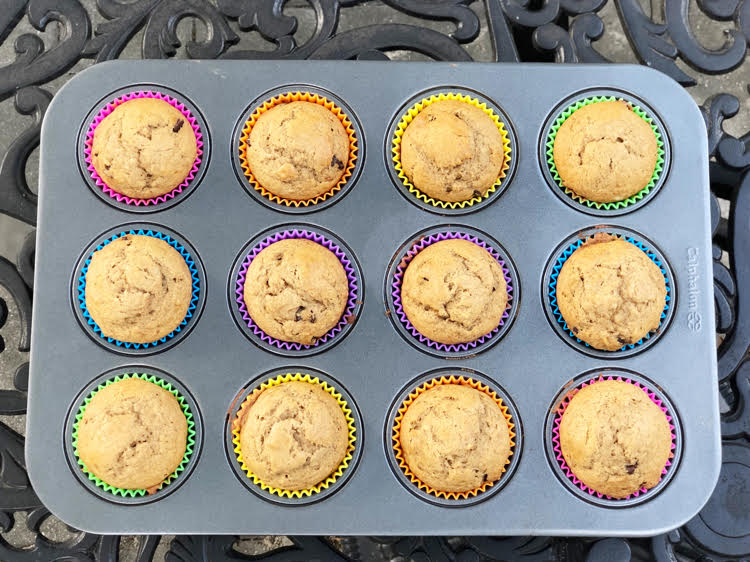 Banana muffins in colorful silicone liners in a muffin tin