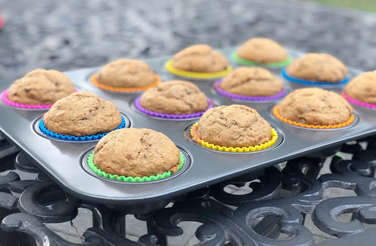 banana chocolate chip muffins in rainbow colored silicone cupcake liners in a muffin tin