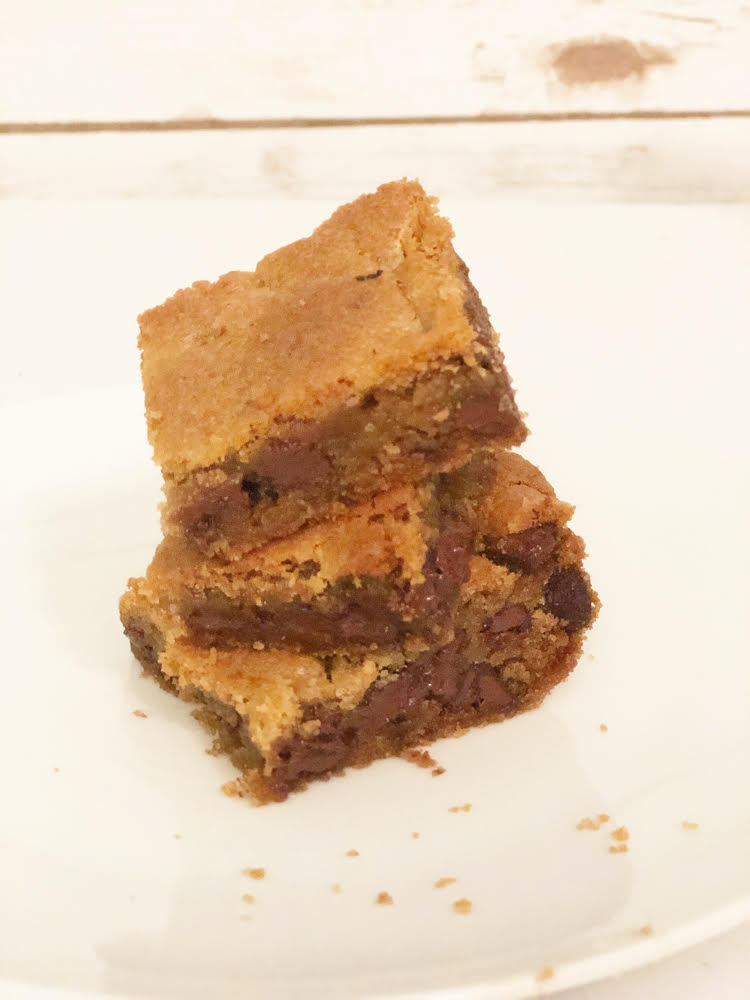 stack of chocolate chip cookies bars on a white plate