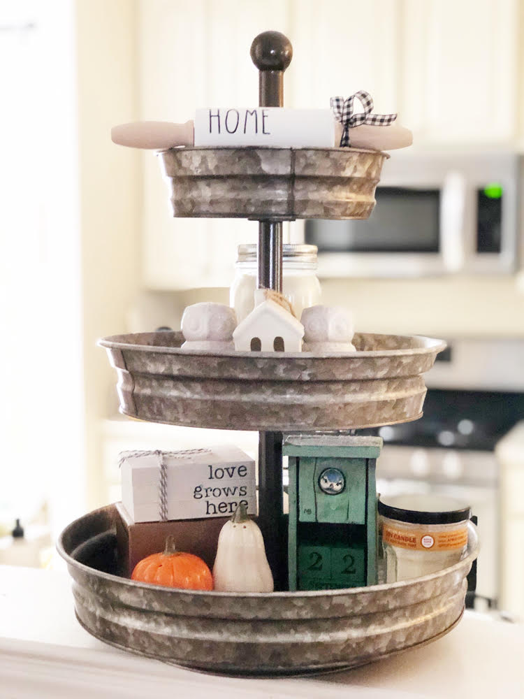 Decorative tiered tray decorated for fall in a white kitchen