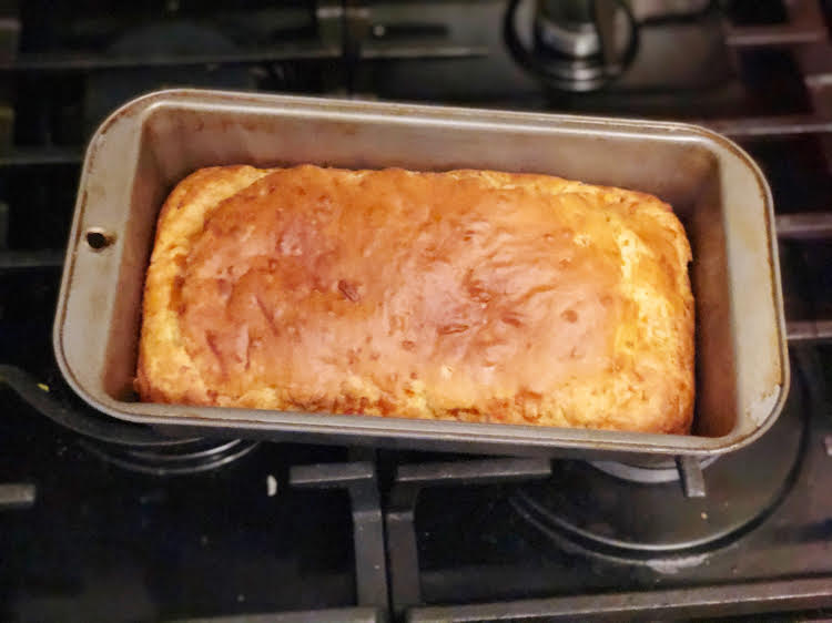 cheddar and green onion bread in a pan on a stove