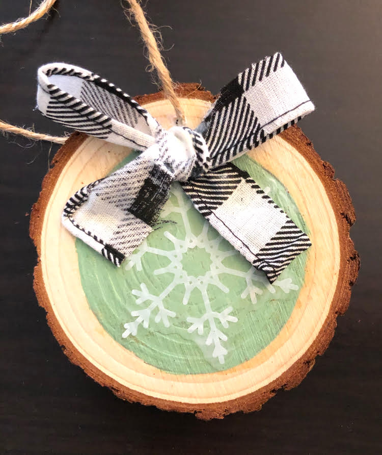 handmade snowflake wood slice ornament with a black and white buffalo plaid bow