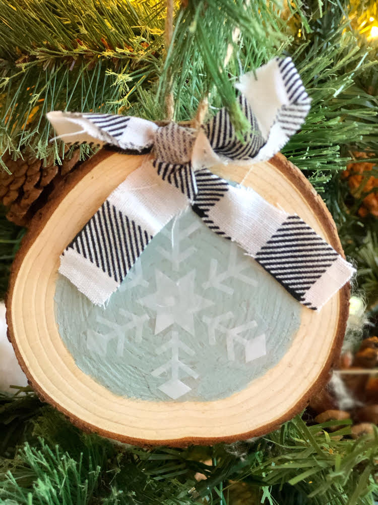 diy snowflake wood slice ornament with a buffalo plaid ribbon