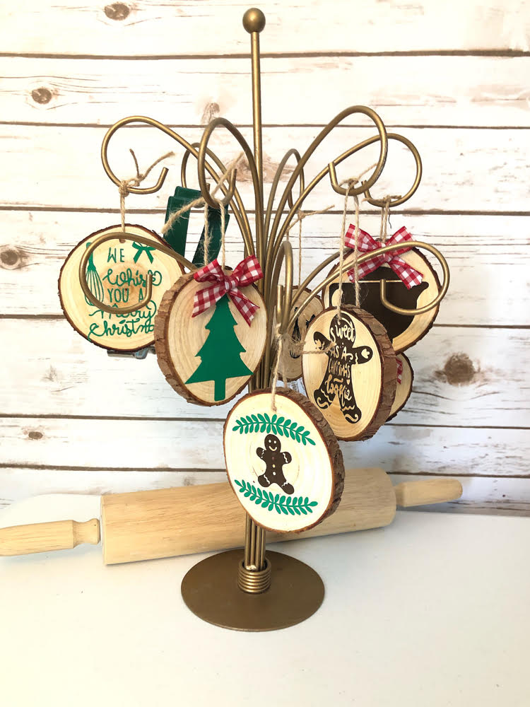 a gold ornament stand with kitchen themed wood slice ornaments.