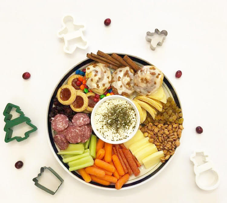 charcuterie board or snack tray for Christmas with cookies, cheeses, meats, snacks and veggies