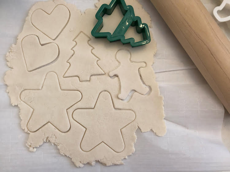 cutting shapes with a cookie cutter for pretty salt dough ornaments for Christmas and the holidays