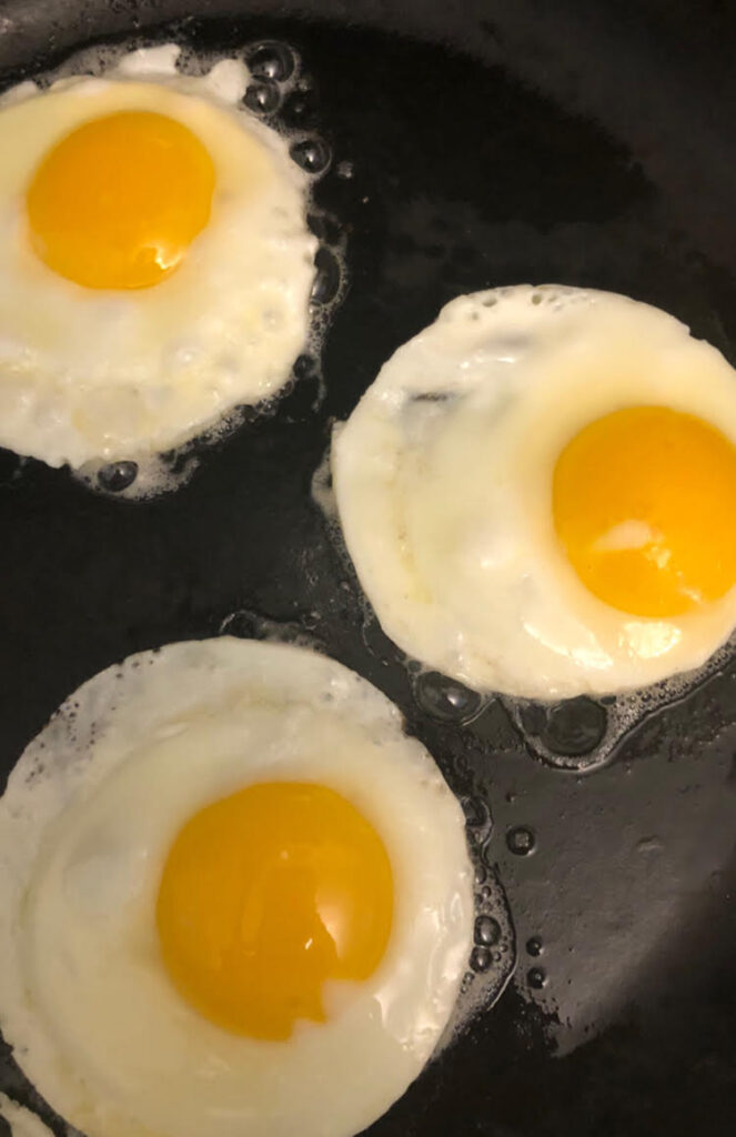 fried eggs in black cast iron pan