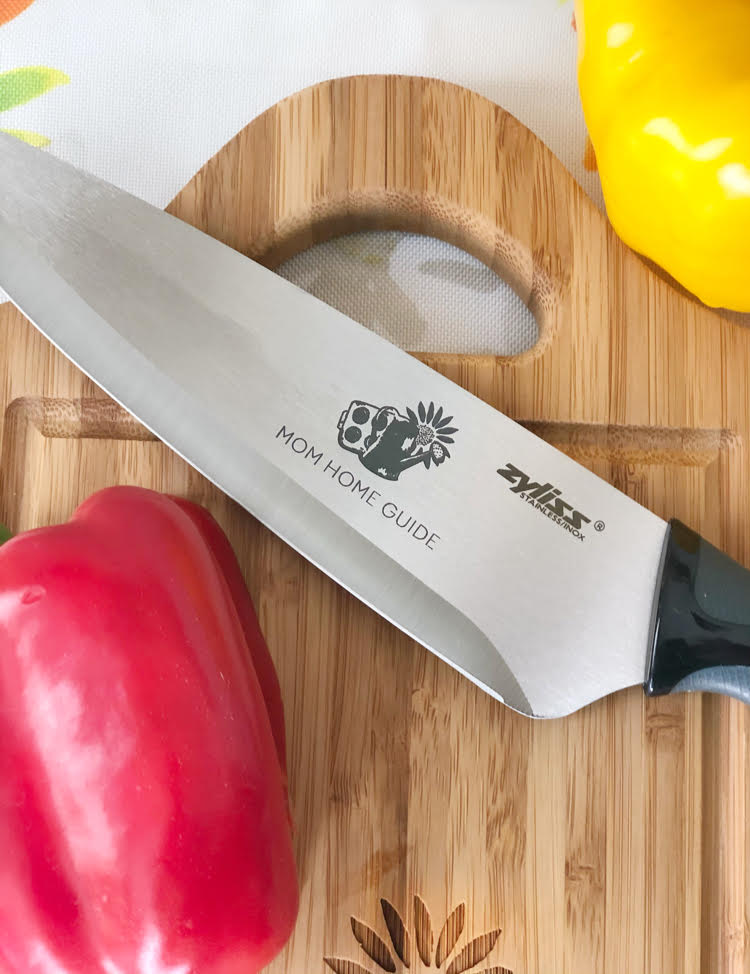 a cutting board and chef knife set engraved with a custom logo