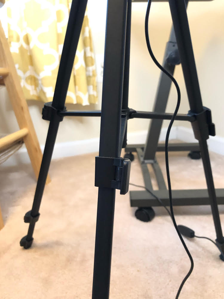 The TONOR ring light stand is lightweight and it's super easy to adjust its height.