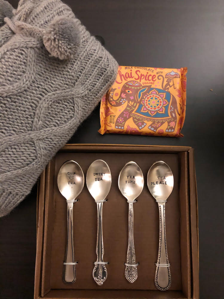 set of hand-stampled teaspoons from World Market, a pair of slipper socks and a chai spice chocolate bar
