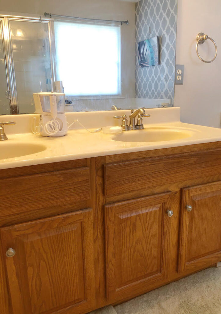 oak bathroom vanity with unframed bathroom mirror