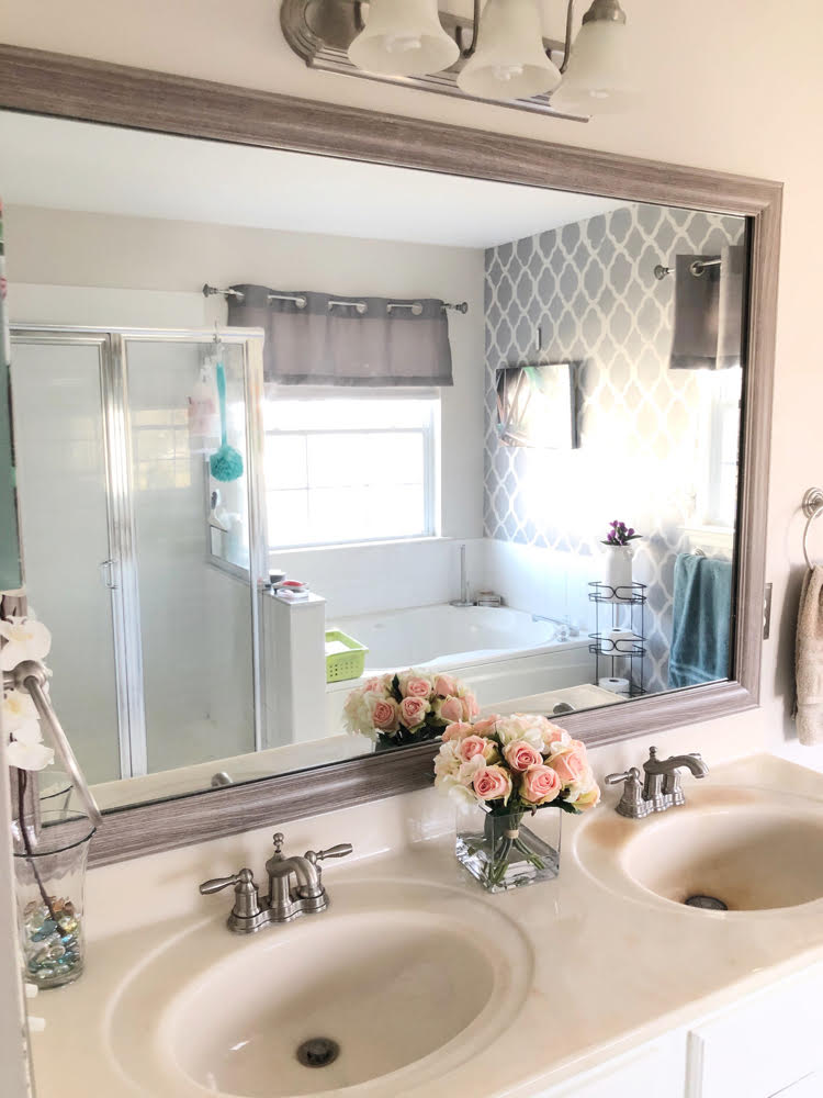 a bathroom mirror framed with a MirrorChic frame