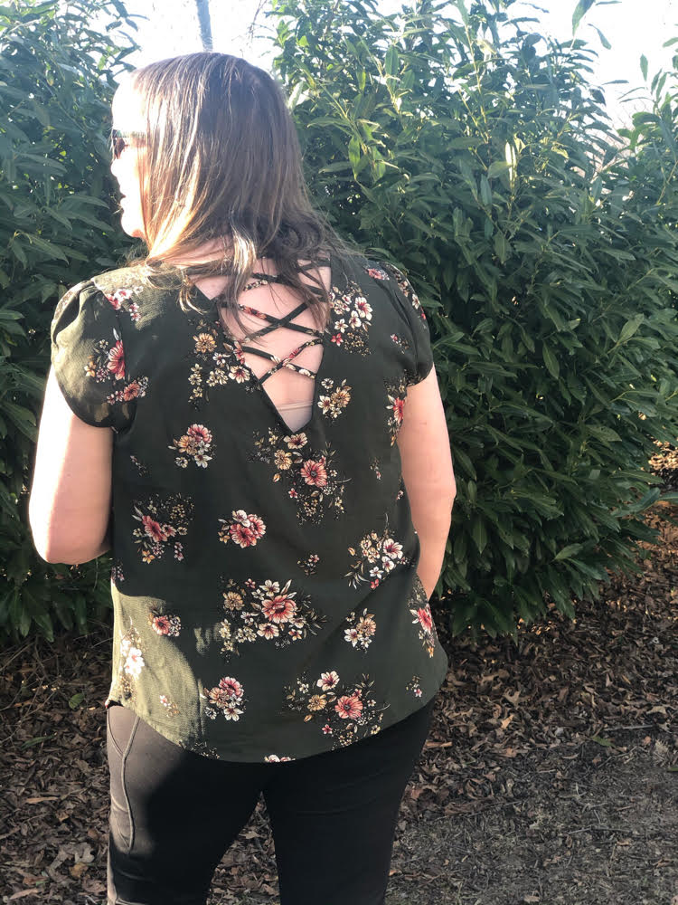 green floral top with an open spaghetti back