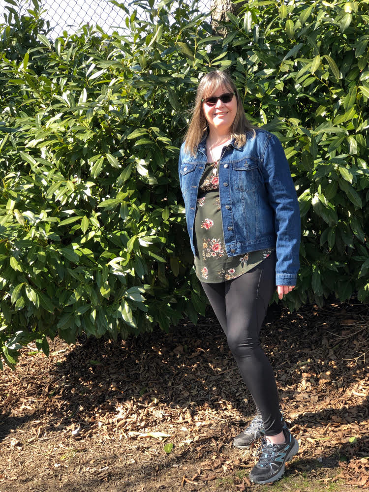 green spring floral top with a denim jacket and black leggings