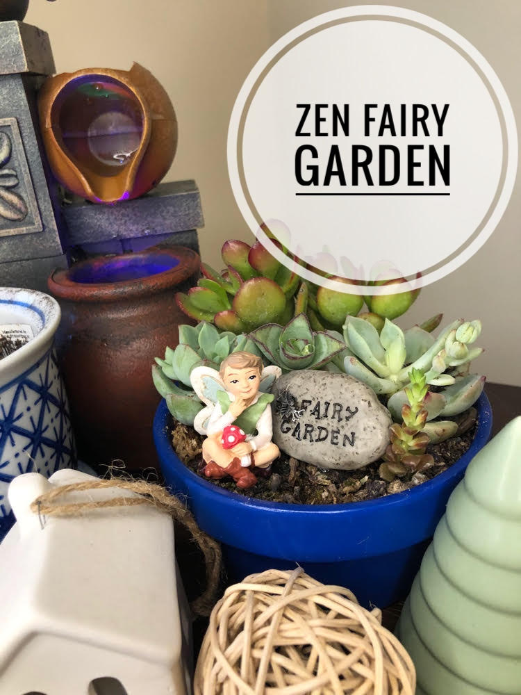 a zen fairy garden with succulents, fairy figuring and tabletop fountain