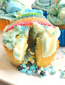 cupcake iced with buttercream icing and filled with sprinkles