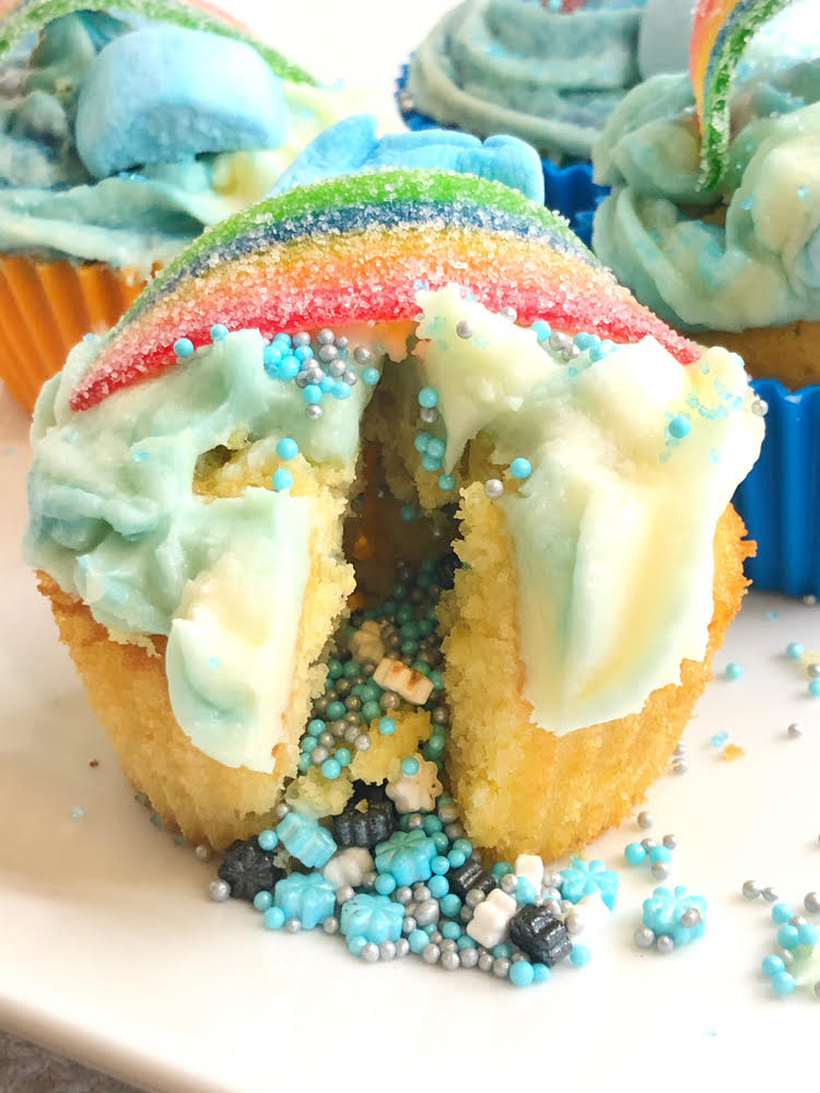 cupcake with sprinkles pouring out of its center