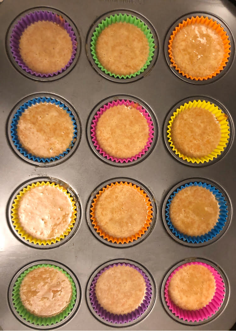 carrot cupcake batter in silicone cupcake liners in nonstick cupcake pan