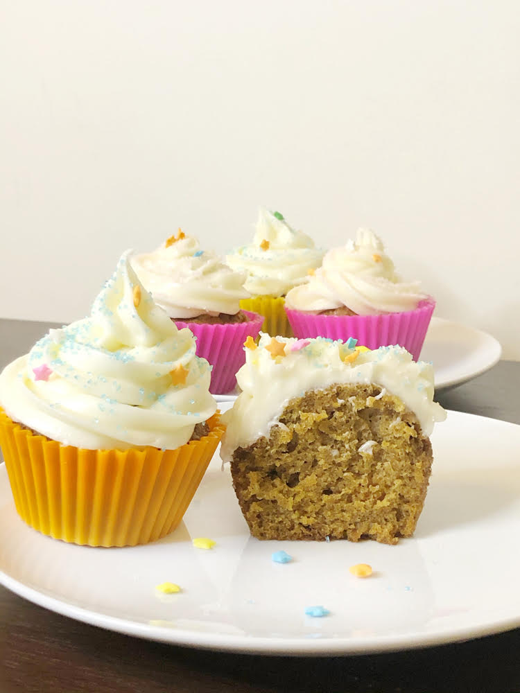 carrot cupcakes with cream cheese icing in colorful silicone cupcake wrappers 