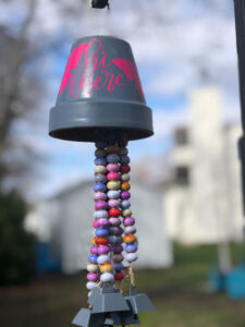 wind chimes made with a terra cotta pot and strings of beads