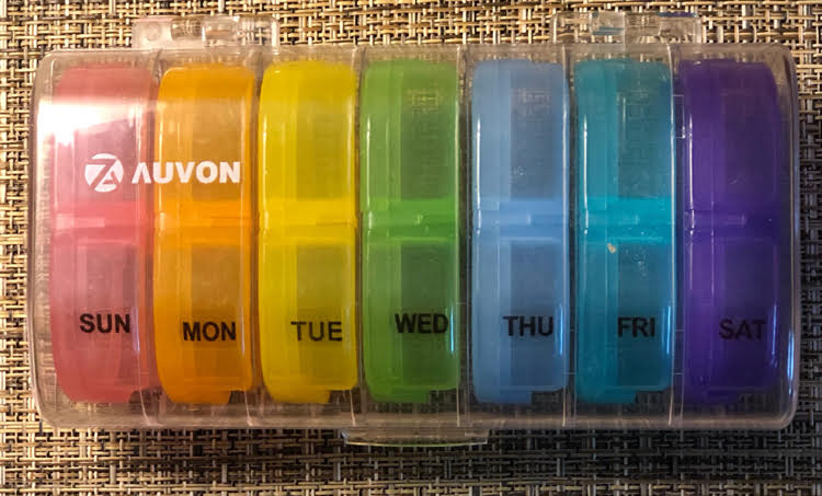 large daily pill organizer with separate daily pill containers with day and night sections