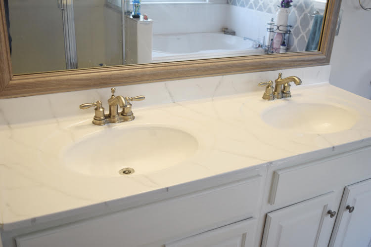 an oak vanity with cultured marble top updated with white paint and a Giani marble countertop kit