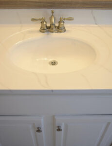 a cultured marble vanity updated with a Giani marble countertop kit and Ekopel sink and tub refinishing coating