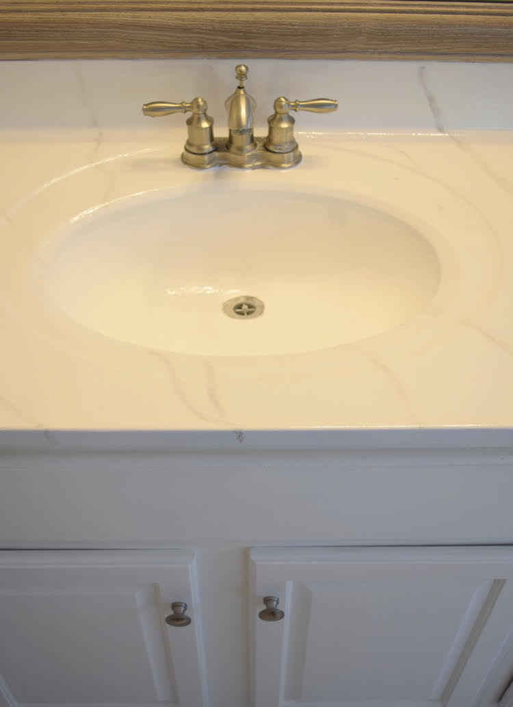 a cultured marble vanity updated with a Giani marble countertop kit and Ekopel sink and tub refinishing coating