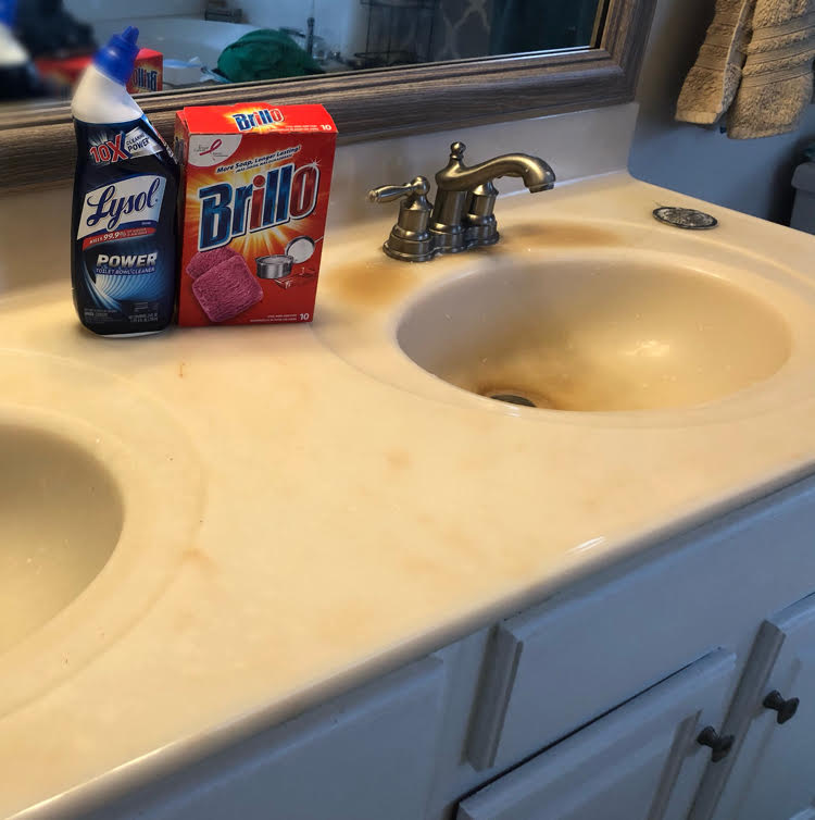 A cultured marble countertop with double sinks before updating them.