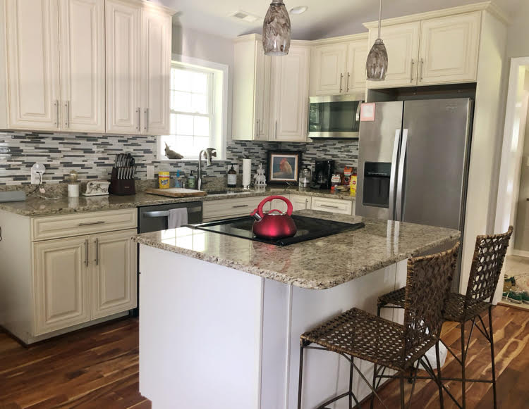 modern kitchen with granite counters and off white cabinets in Annapolis 2 bedroom Airbnb