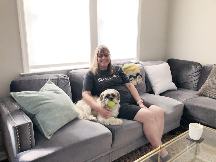 Lauren of Mom Home Guide enjoys the comfy sectional in the Annapolis Airbnb she rented with her family and puppy