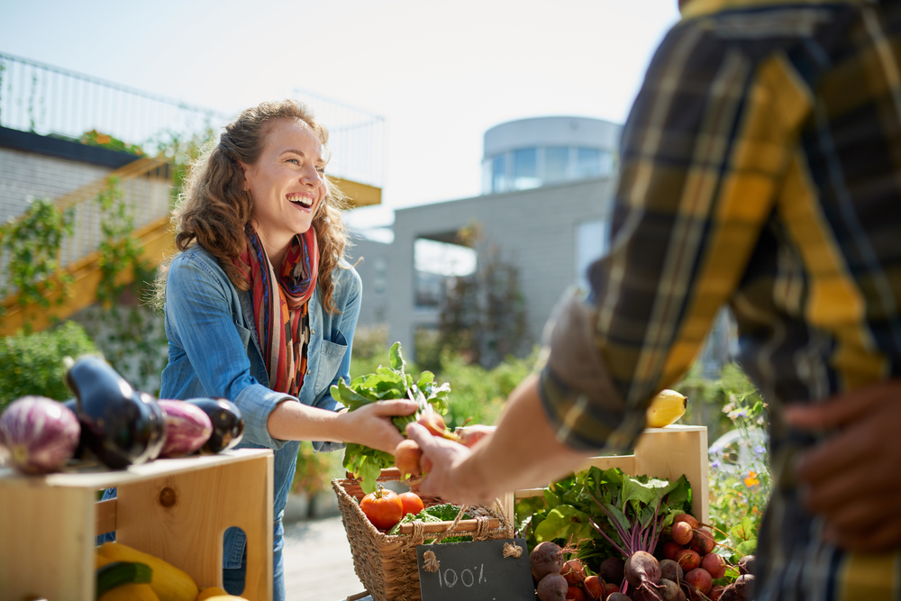 woman with fresh vegetables at a farmer's market