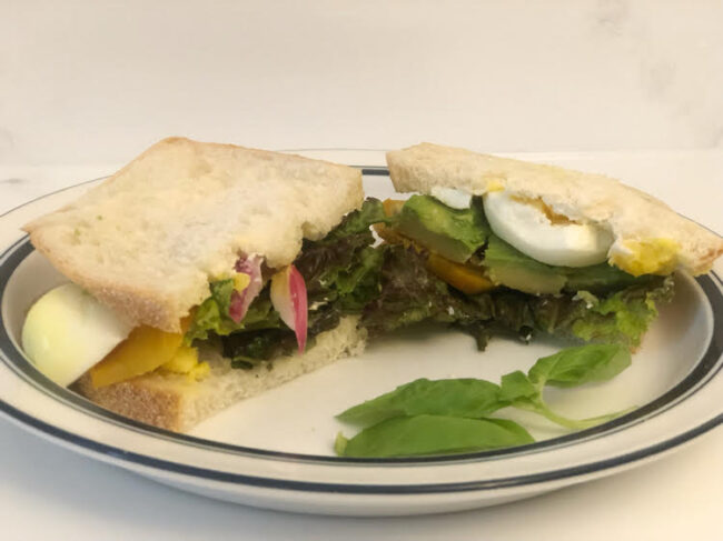 roasted beets, avocado, hardboiled egg, pickled onion, lettuce and basil on sourdough bread