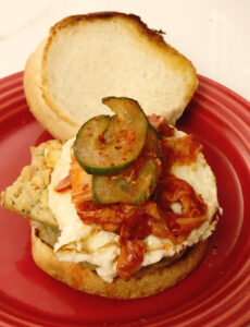 veggie brat sandwich with a fried egg and kimchi