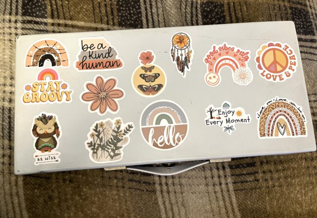 Boho stickers on an antique tin