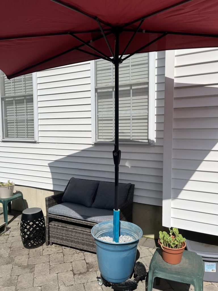 I love my inexpensive and easy to make flower-pot umbrella stand.