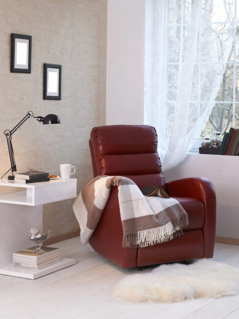 Red recliner with a cozy blanket