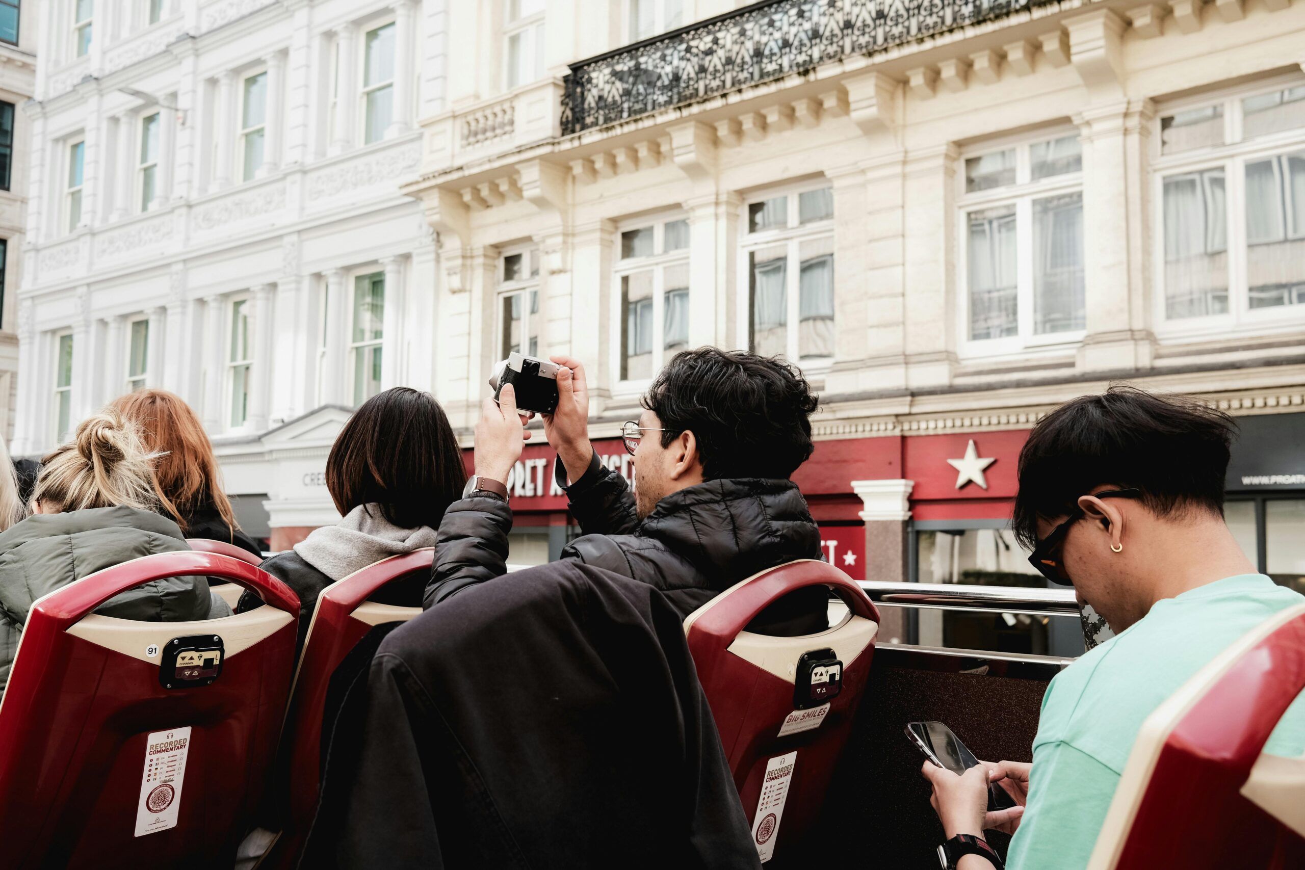 tourists traveling on a doubledecker bus in London